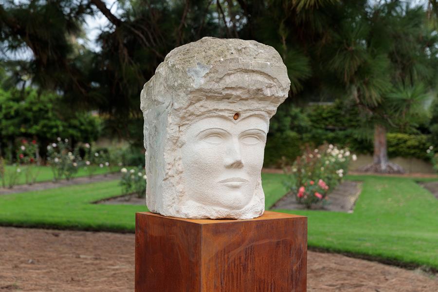 Artist Adrian Spurr poses with his sculpture in the Billilla garden.